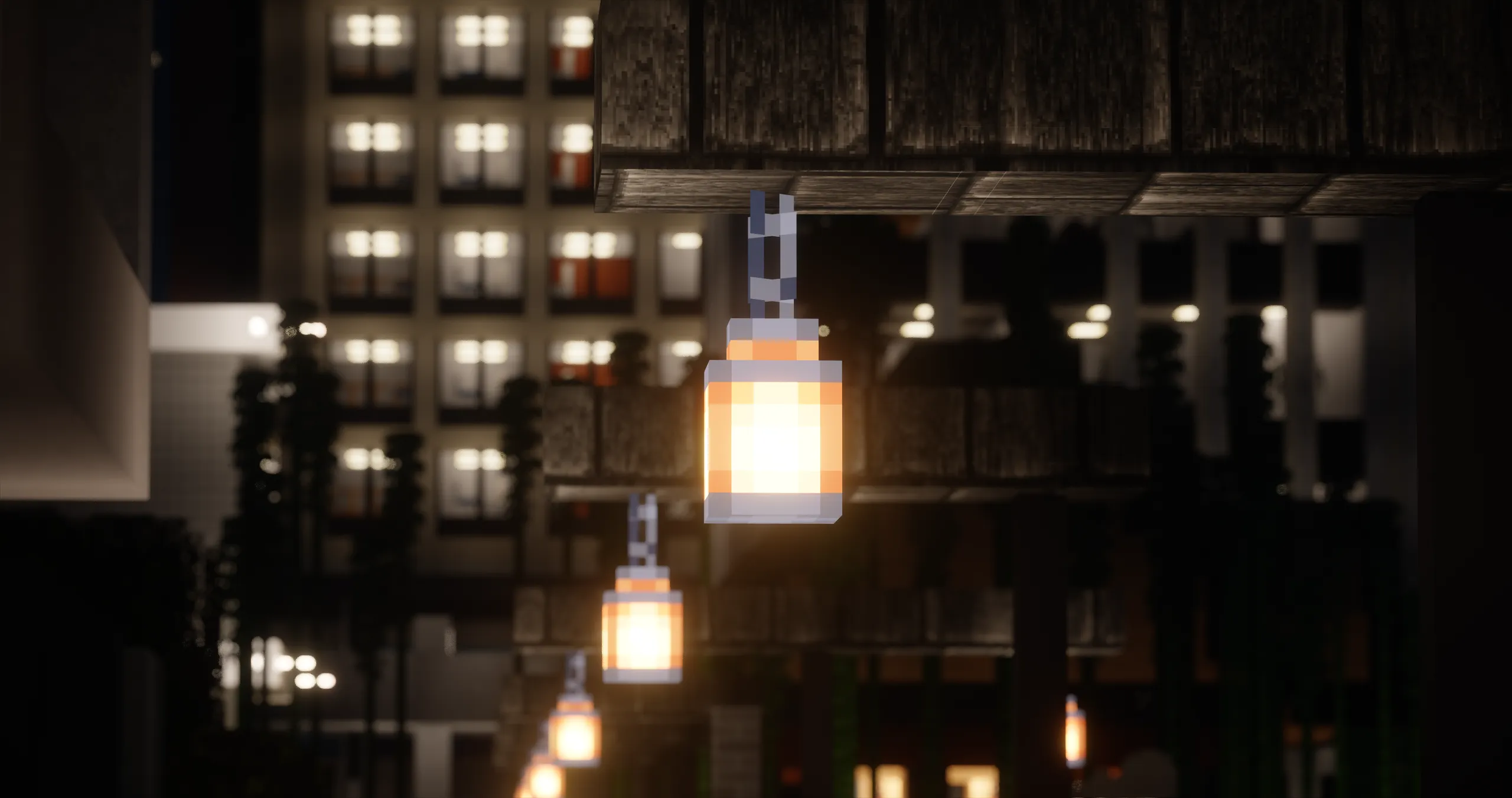 A row of street lights glowing in front of Pyutocor buildings at night